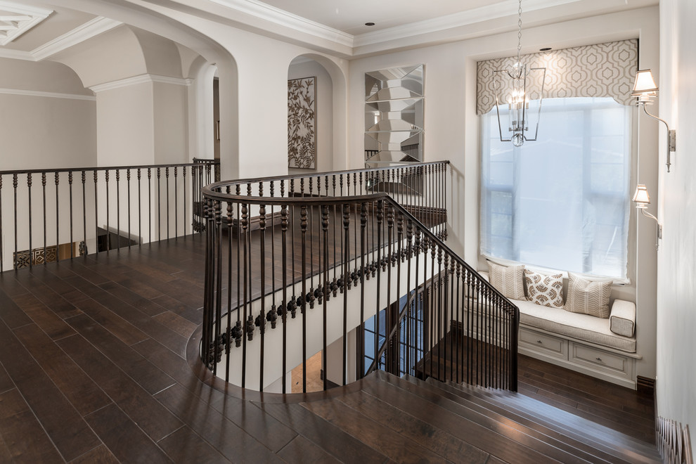 Expansive mediterranean wood u-shaped mixed railing staircase in Phoenix with wood risers.