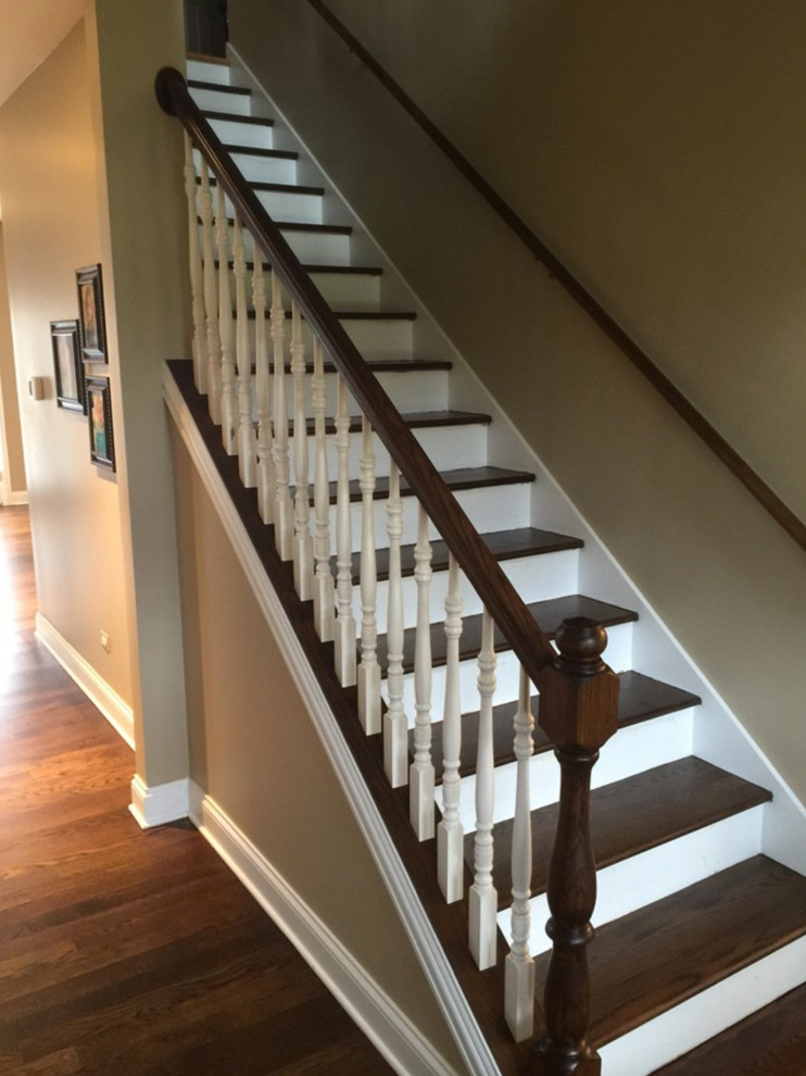 Medium sized classic wood straight wood railing staircase in Omaha with painted wood risers.