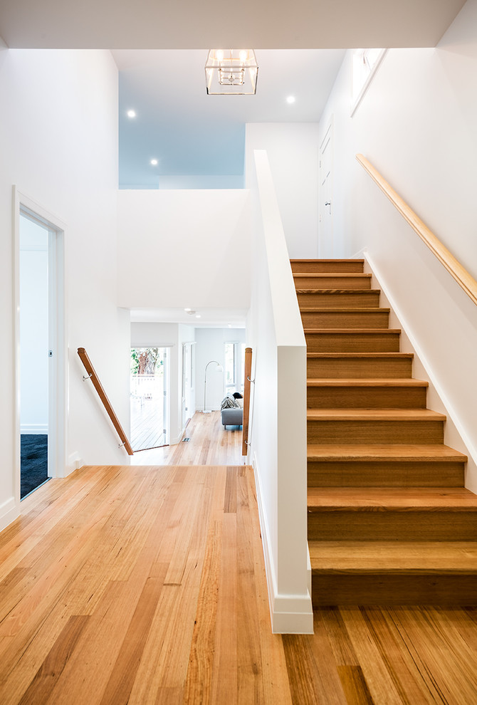 This is an example of a medium sized contemporary wood straight wood railing staircase in Melbourne with wood risers.