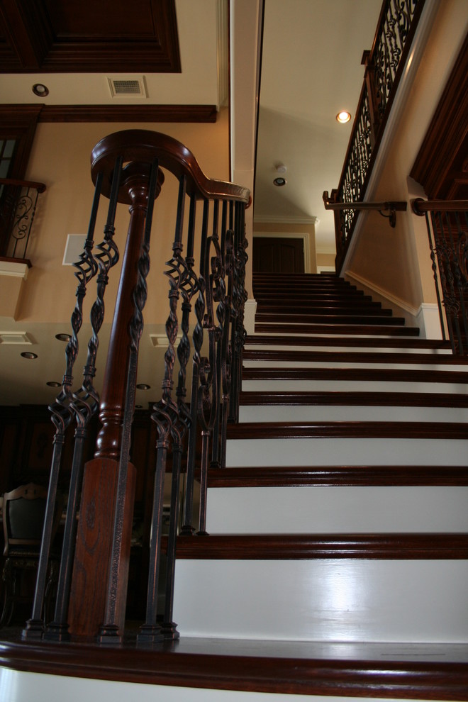 Example of a large tuscan wooden straight staircase design in Orlando with wooden risers