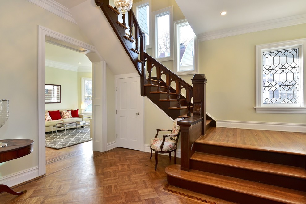 This is an example of a medium sized victorian wood u-shaped staircase in New York with wood risers.