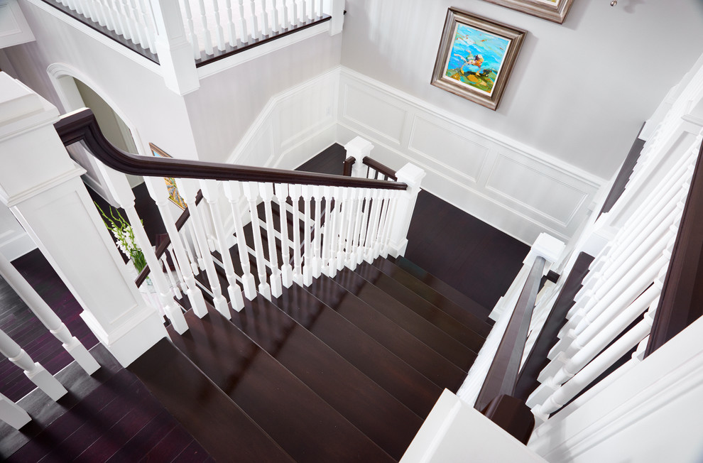 Example of a large trendy wooden u-shaped staircase design in Philadelphia with painted risers