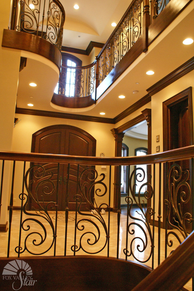 Expansive traditional wood floating staircase in Chicago with wood risers.