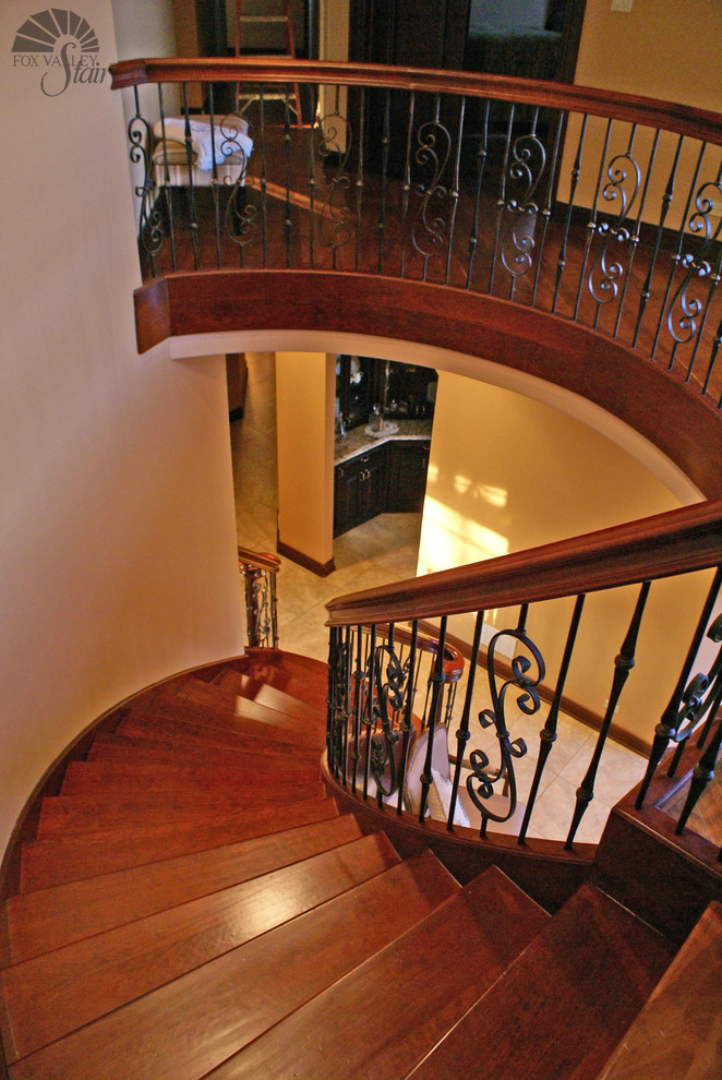 Example of a huge classic wooden floating staircase design in Chicago with wooden risers
