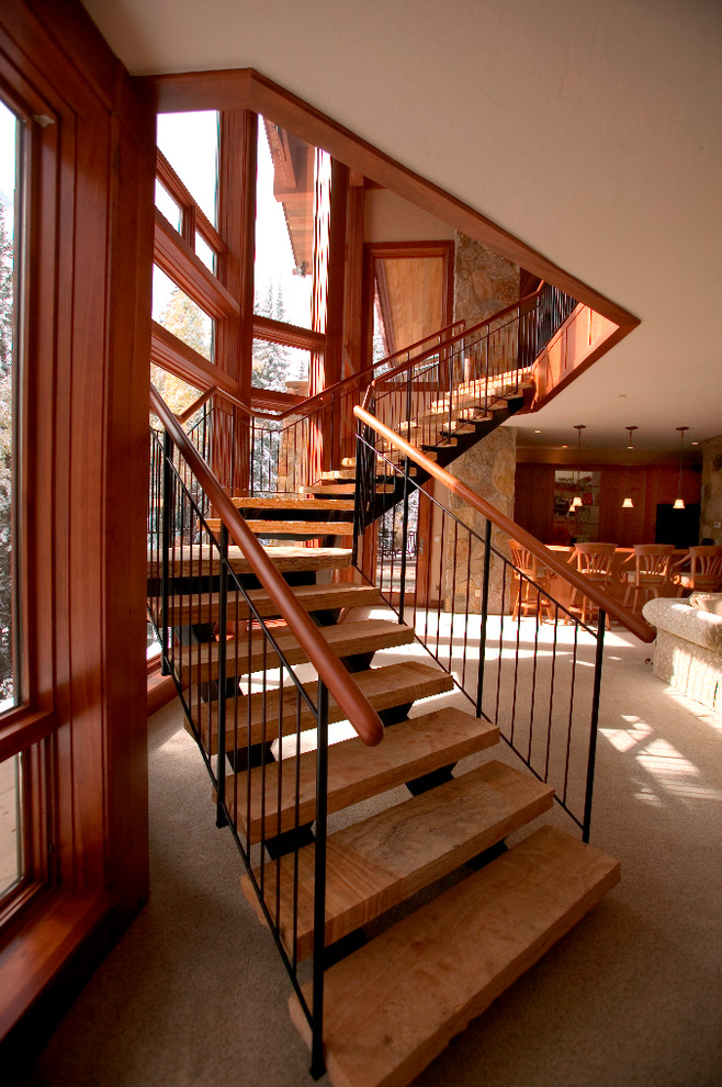 Large contemporary wood curved staircase in Denver with open risers.