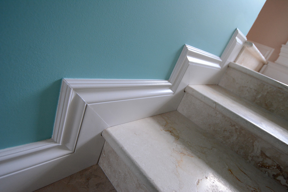 Traditional staircase in Miami with limestone treads and limestone risers.