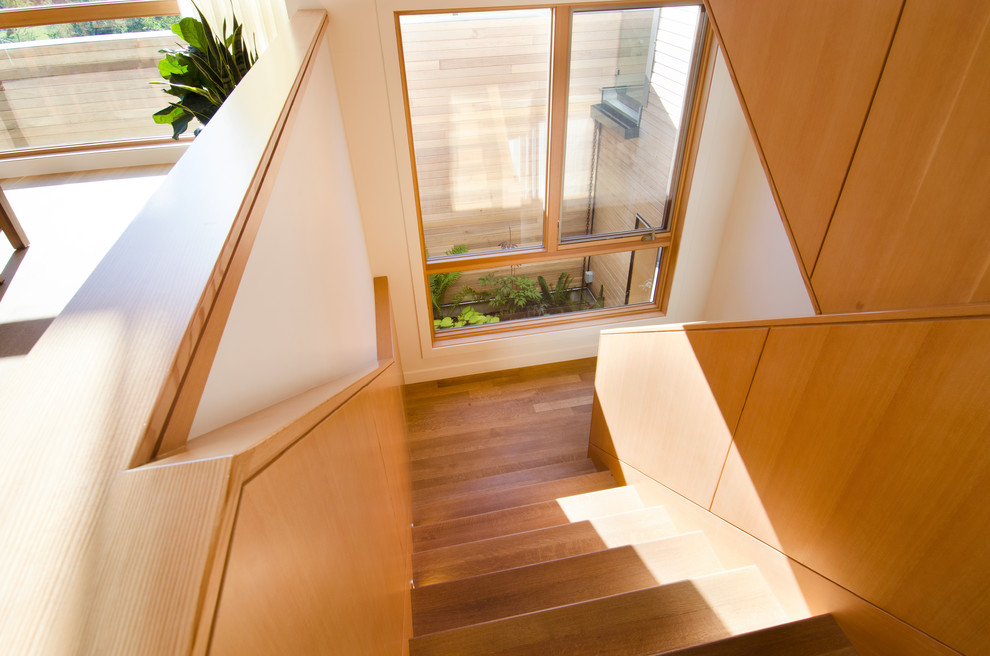 Mid-sized trendy wooden floating staircase photo in Calgary with wooden risers