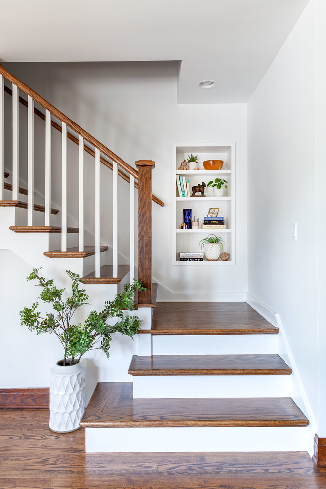 Inspiration for a classic wood curved wood railing staircase in Chicago with painted wood risers.