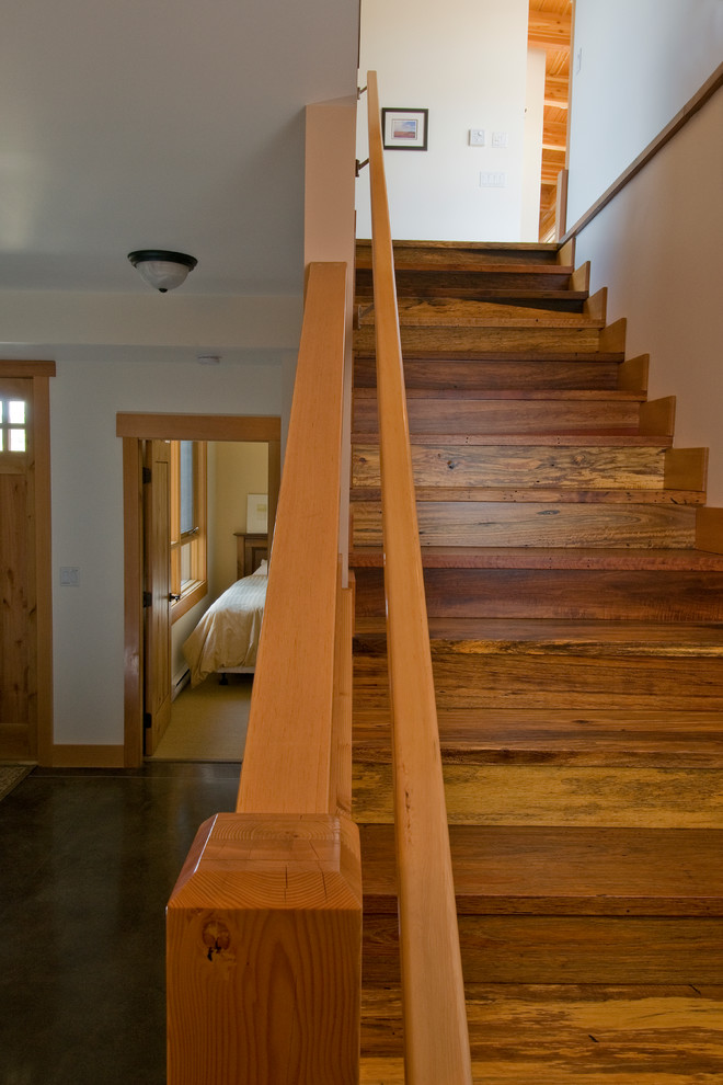This is an example of a medium sized rustic wood straight staircase in Vancouver with wood risers.