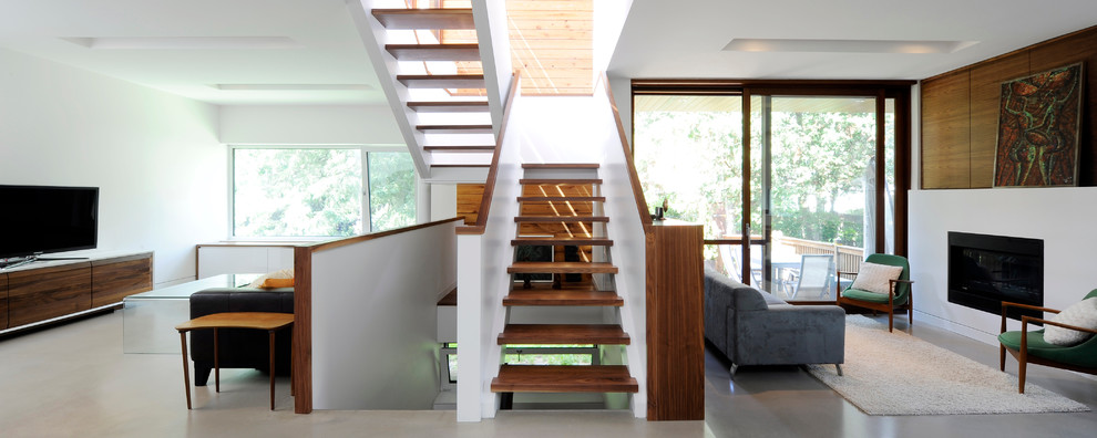 Diseño de escalera suspendida actual con escalones de madera