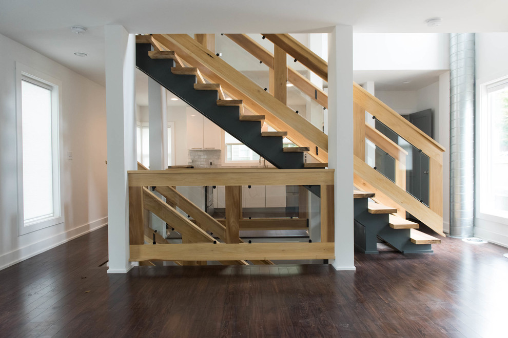 Photo of a large contemporary wood straight wood railing staircase in Indianapolis with metal risers.