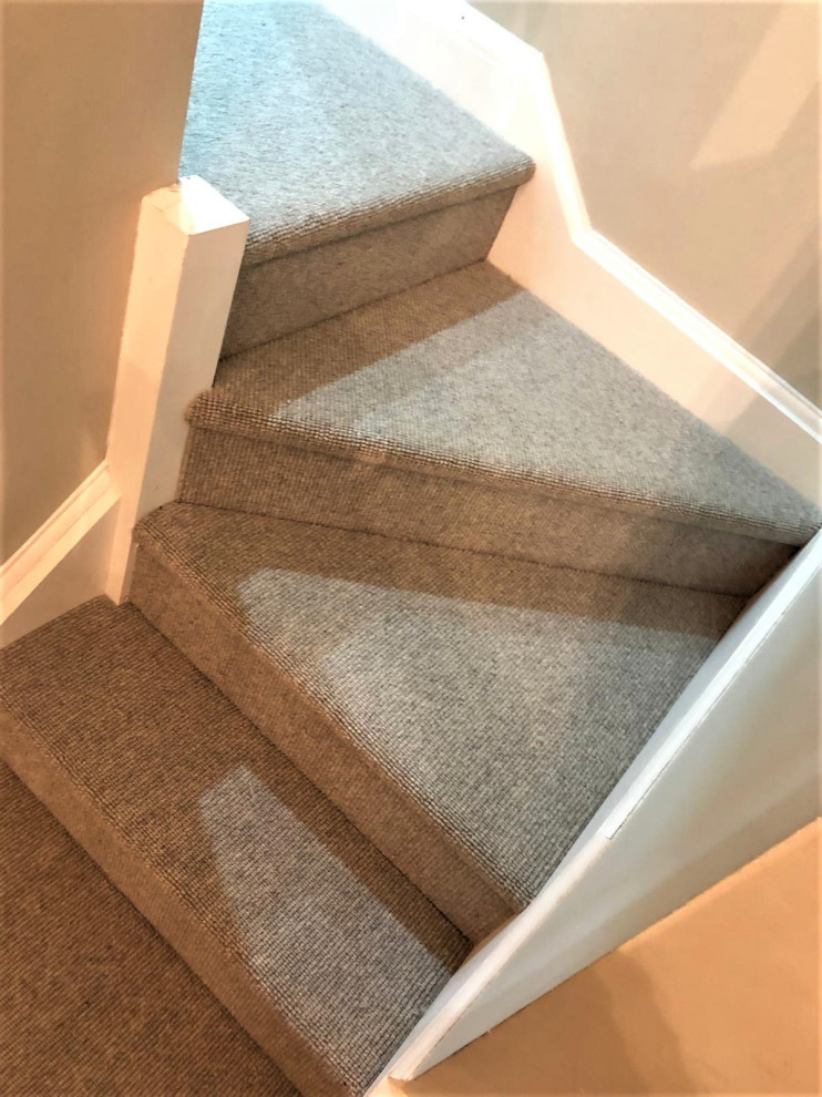 Example of a mid-sized minimalist l-shaped staircase design in Hertfordshire with wooden risers