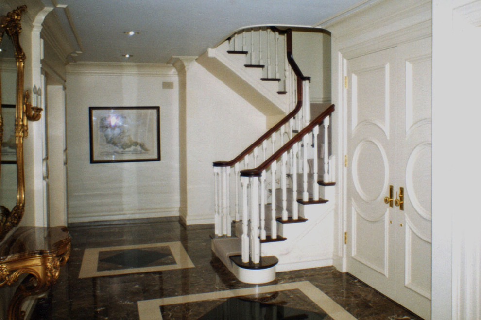 Example of a large classic wooden l-shaped wood railing staircase design in Boston with painted risers