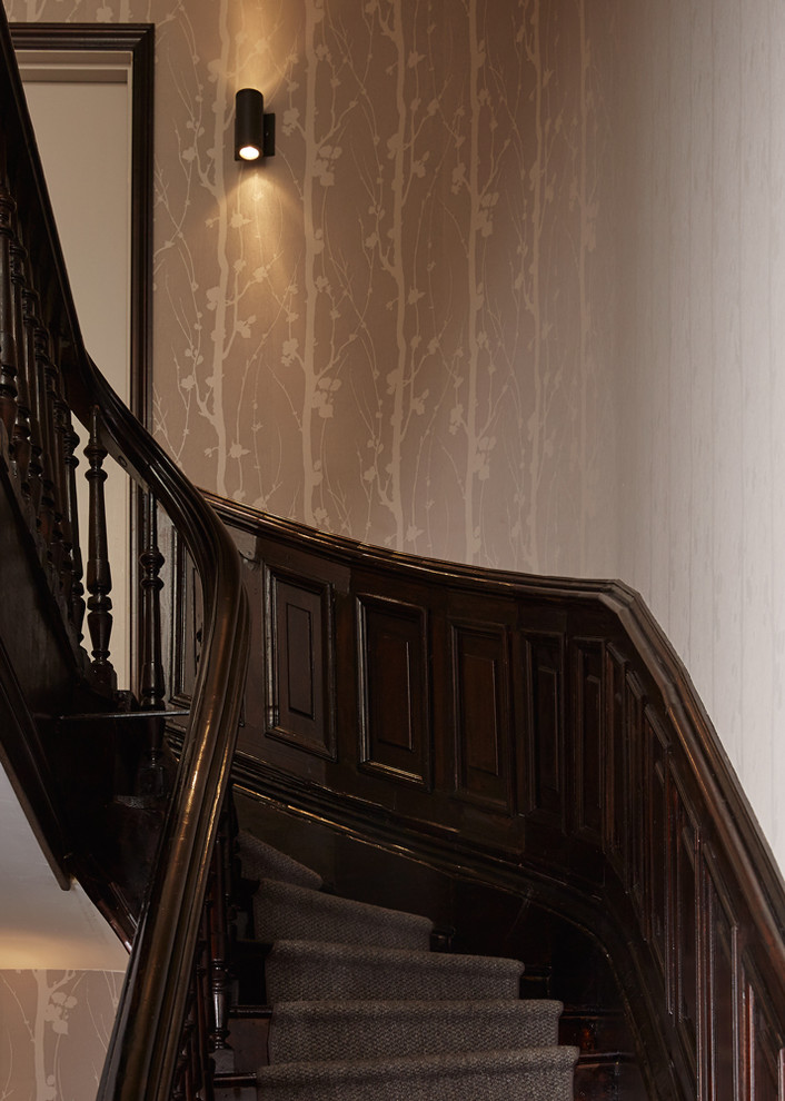 Staircase - large transitional wooden curved staircase idea in New York with wooden risers