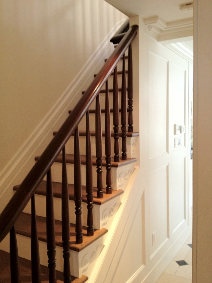 Inspiration for a mid-sized timeless wooden straight staircase remodel in New York with wooden risers