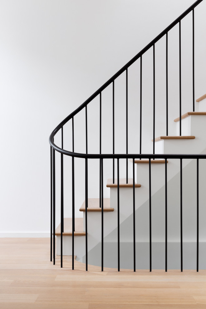 Inspiration for a small contemporary wood l-shaped metal railing staircase in New York with painted wood risers.
