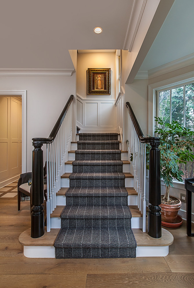 Staircase - mid-sized transitional carpeted l-shaped wood railing staircase idea in Detroit with wooden risers
