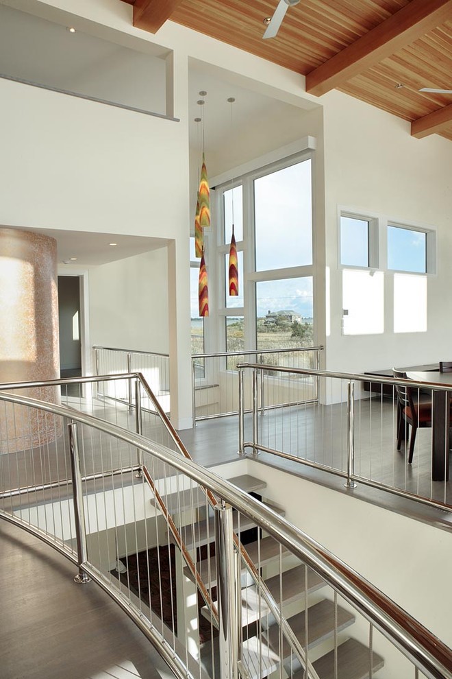 Staircase - contemporary open and cable railing staircase idea in New York