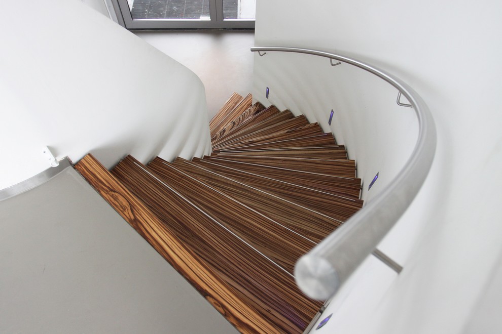 Staircase - modern wooden curved staircase idea in Amsterdam