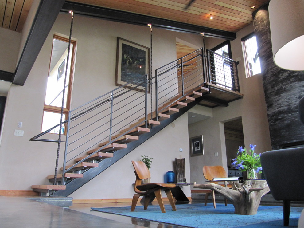 Modern wood straight staircase in Other with open risers.