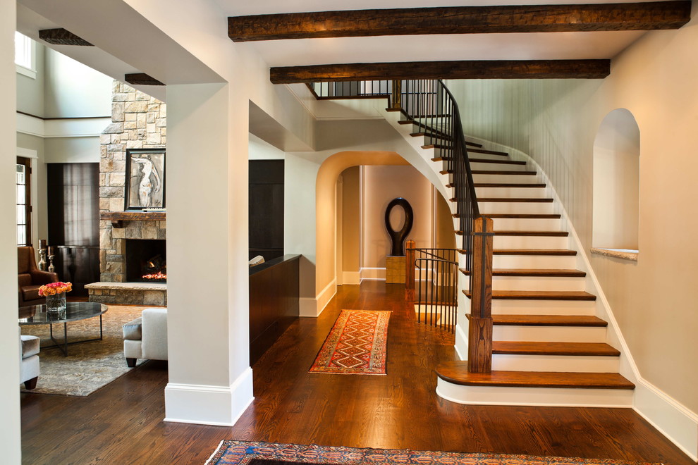 Staircase - mid-sized transitional wooden curved staircase idea in Atlanta with painted risers