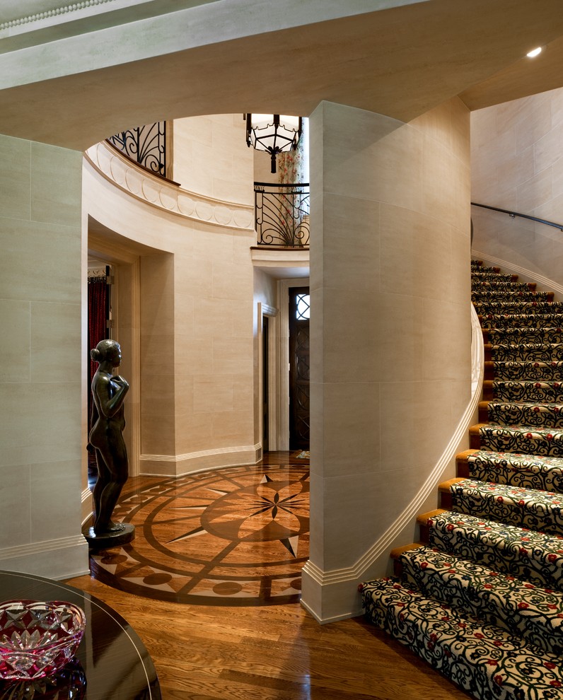 Стильный дизайн: изогнутая лестница в классическом стиле с ступенями с ковровым покрытием и ковровыми подступенками - последний тренд