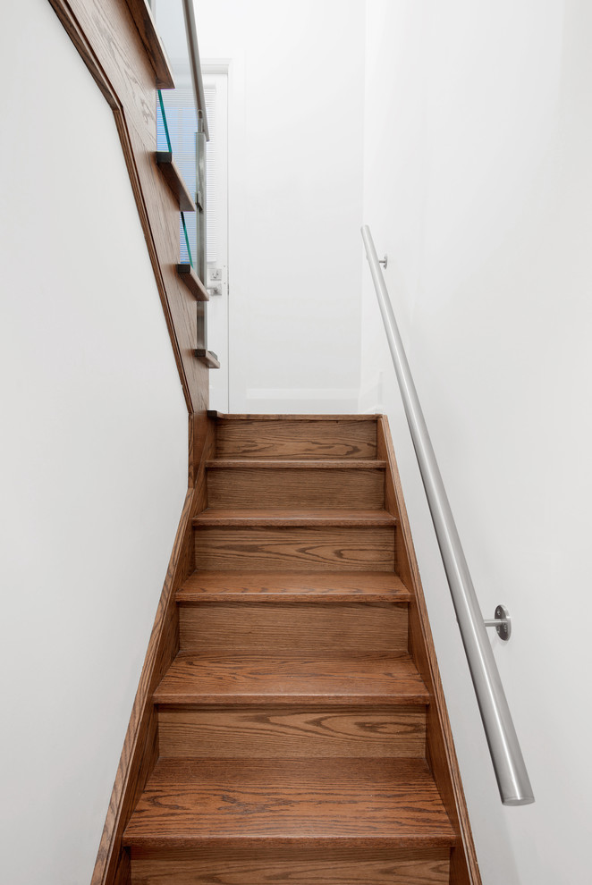 Photo of a small classic wood u-shaped staircase in Toronto with wood risers.