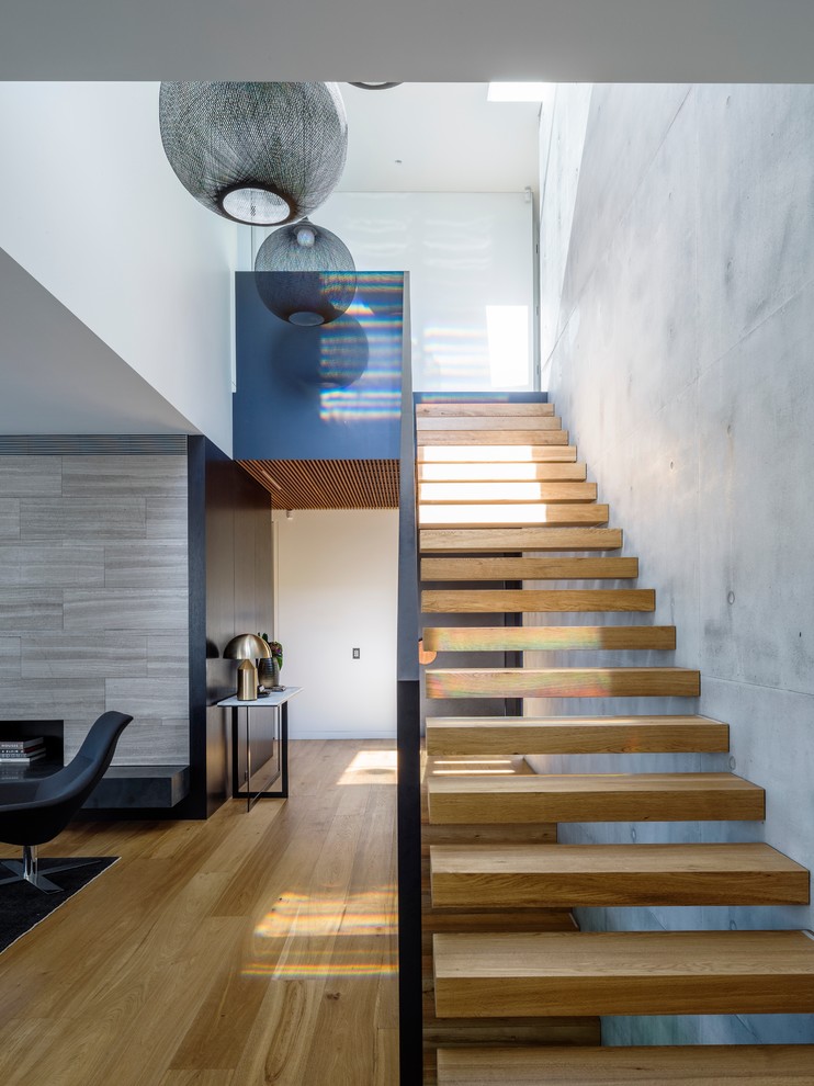 Idées déco pour un escalier sans contremarche droit contemporain avec des marches en bois.