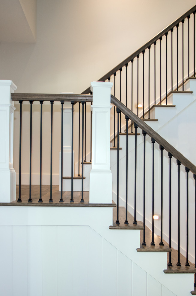 Mixed material railing staircase photo in Other with wooden risers