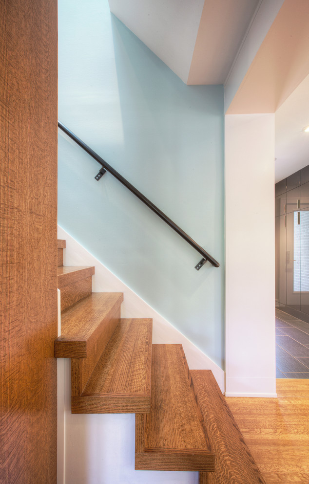 Medium sized scandinavian wood straight staircase in Indianapolis with wood risers.