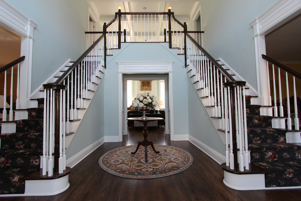 Inspiration for a large timeless carpeted straight wood railing staircase remodel in New York with painted risers
