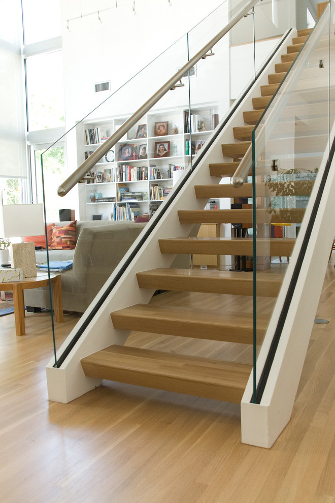 This is an example of a contemporary staircase in Austin with feature lighting.