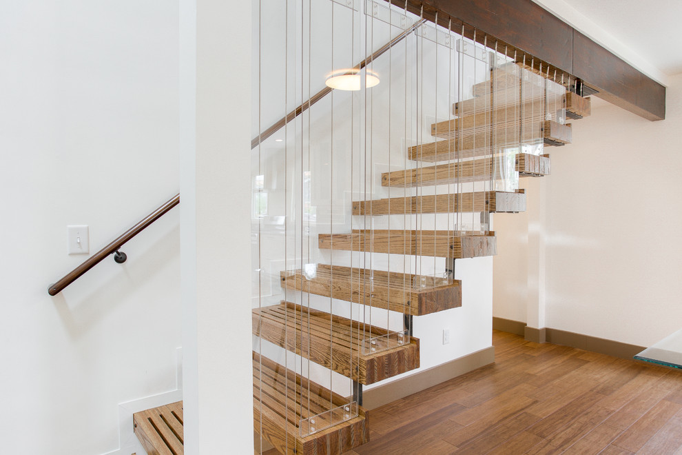 Photo of a medium sized contemporary floating glass railing staircase in Richmond with wood risers.