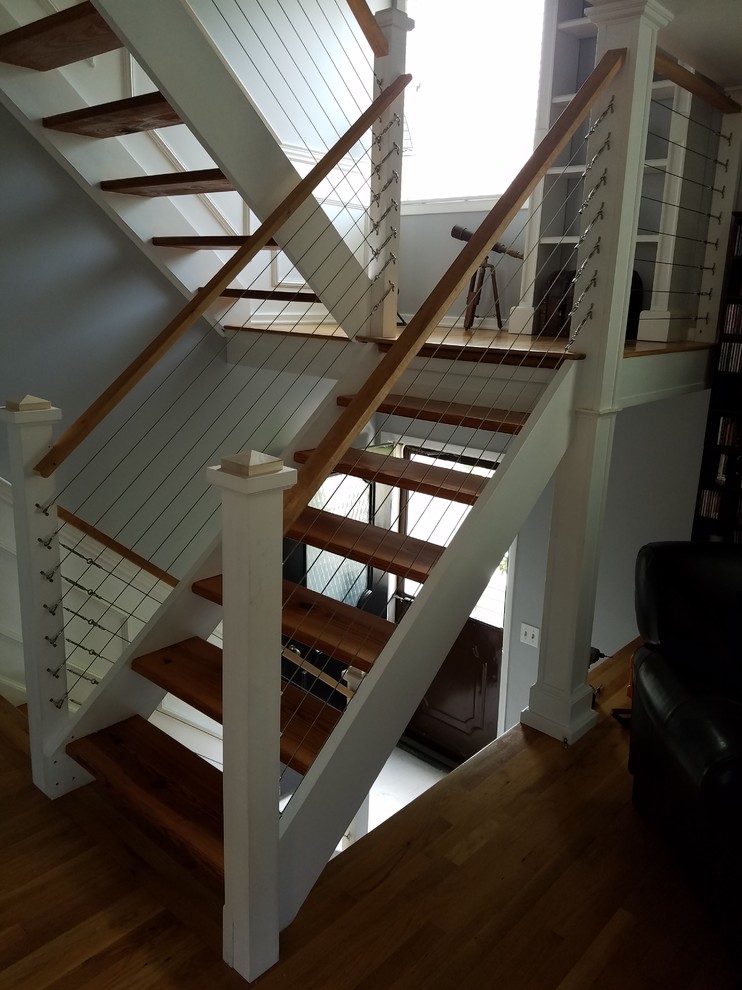 Diseño de escalera en U tradicional renovada sin contrahuella con escalones de madera y barandilla de madera