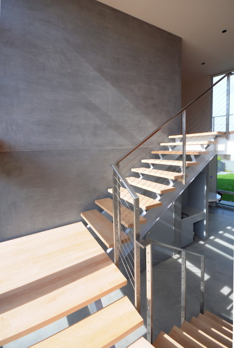 Inspiration for a contemporary wood floating staircase in Los Angeles with open risers.