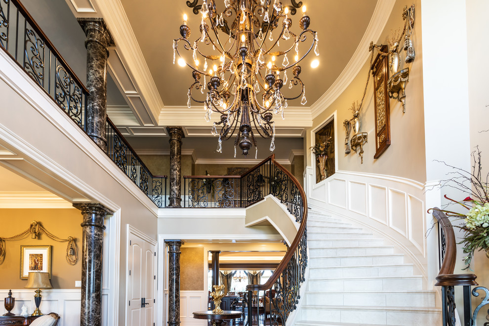 Design ideas for a large traditional curved mixed railing staircase in Other with limestone treads, limestone risers and feature lighting.