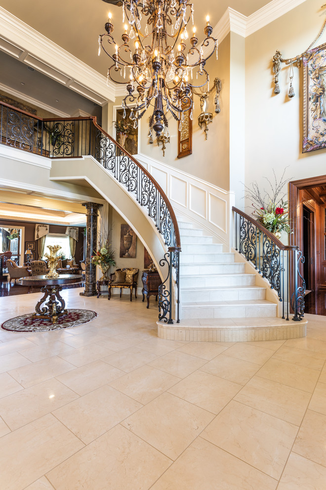 Large traditional curved mixed railing staircase in Other with limestone treads and limestone risers.