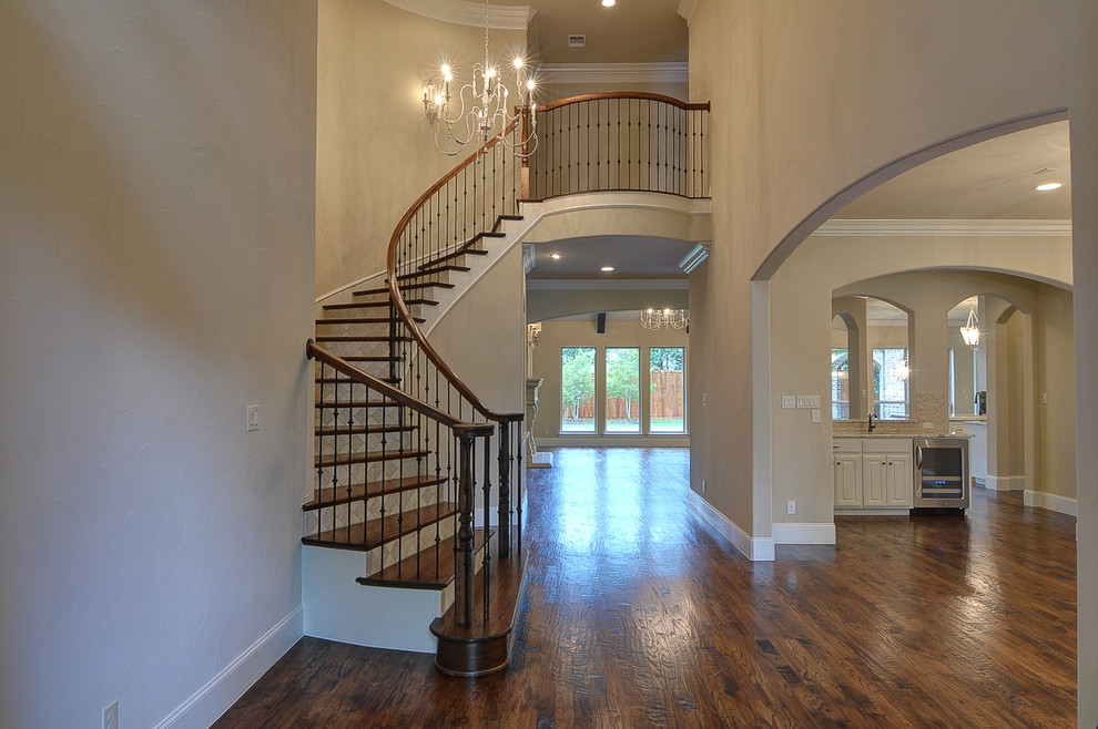 Elegant wooden staircase photo in Dallas with tile risers