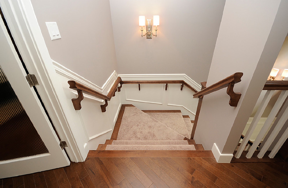 Staircase - mid-sized traditional wooden u-shaped wood railing staircase idea in Edmonton with wooden risers