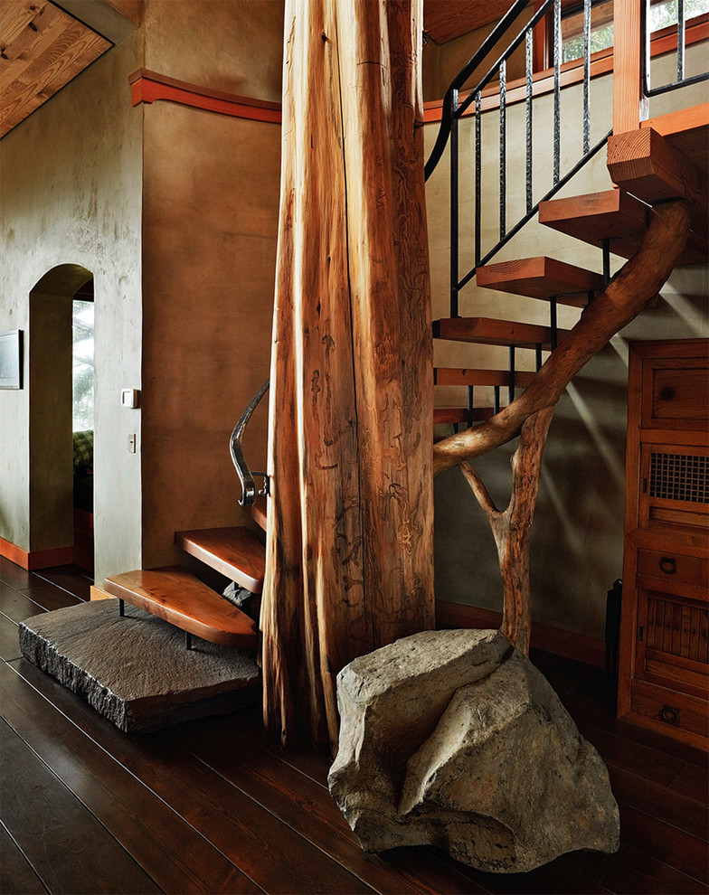 Inspiration for a medium sized rustic wood curved staircase in Portland with open risers.