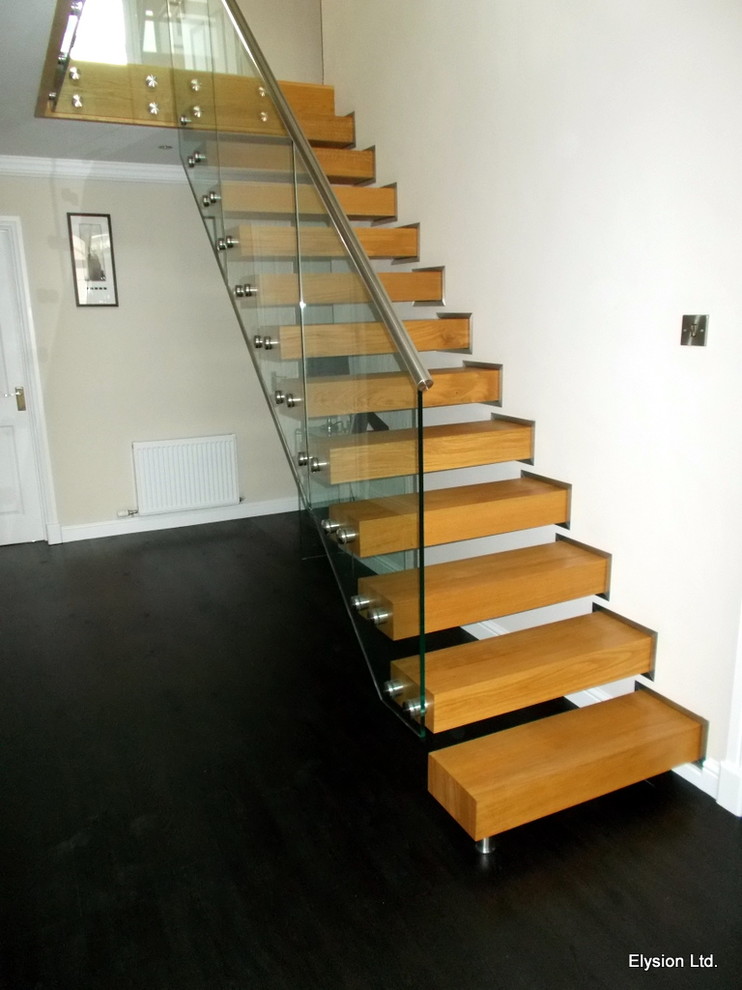 This is an example of a small modern wood floating mixed railing staircase in Other.