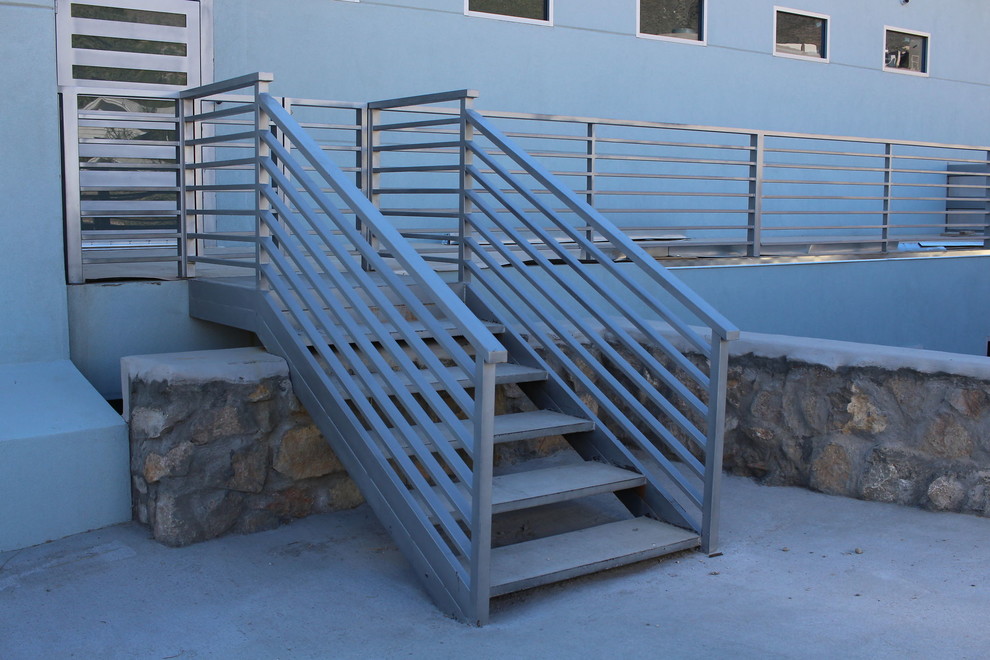 Diseño de escalera recta minimalista de tamaño medio con escalones de metal, contrahuellas de metal y barandilla de metal