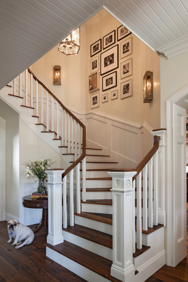 Large beach style wooden curved staircase photo in Los Angeles with wooden risers