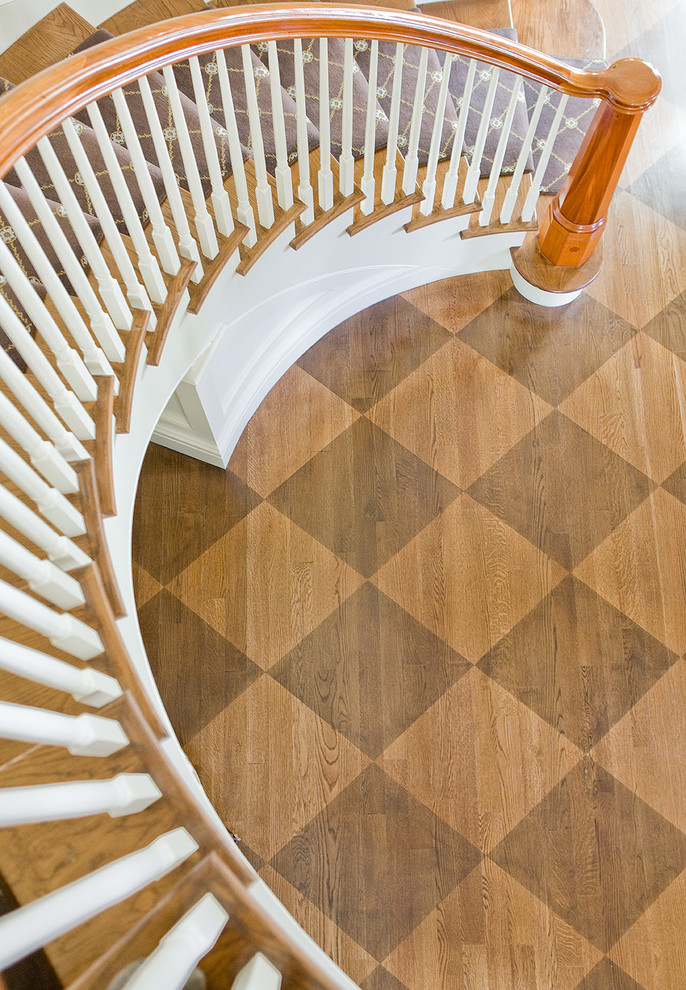 Example of a large ornate wooden curved staircase design in Boston with painted risers