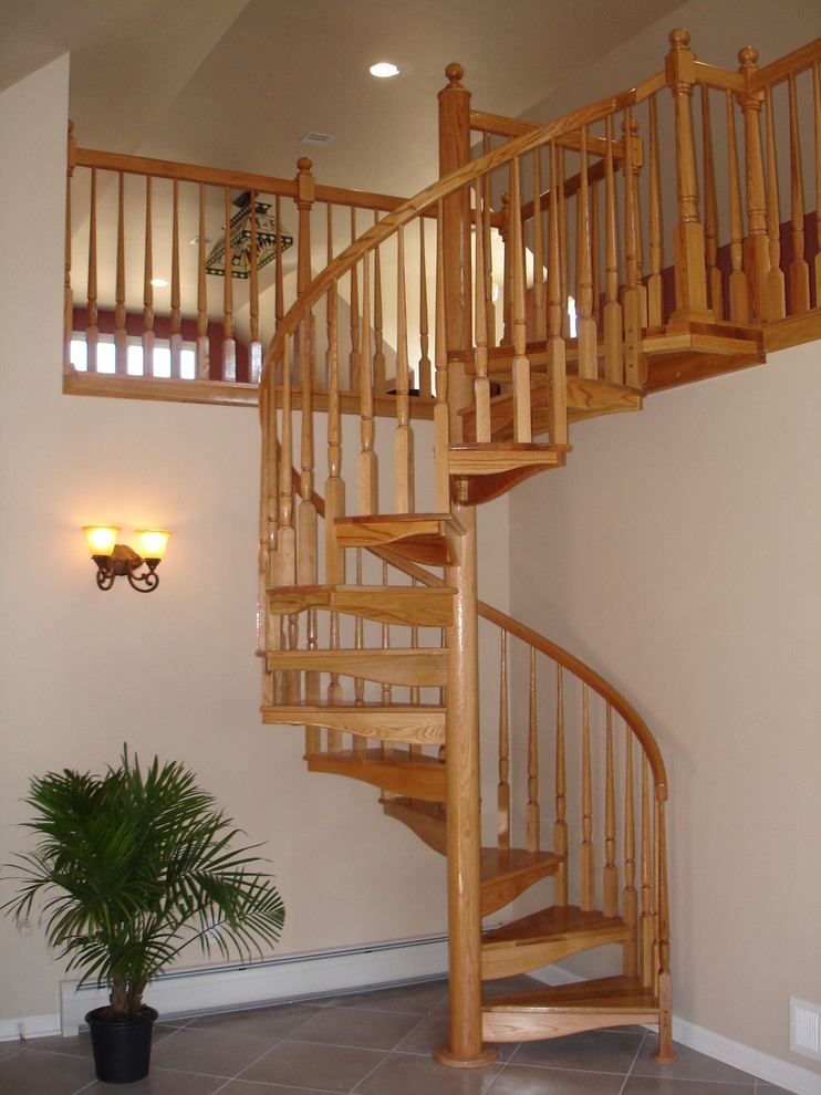 Example of a mid-sized classic wooden spiral open staircase design in Newark