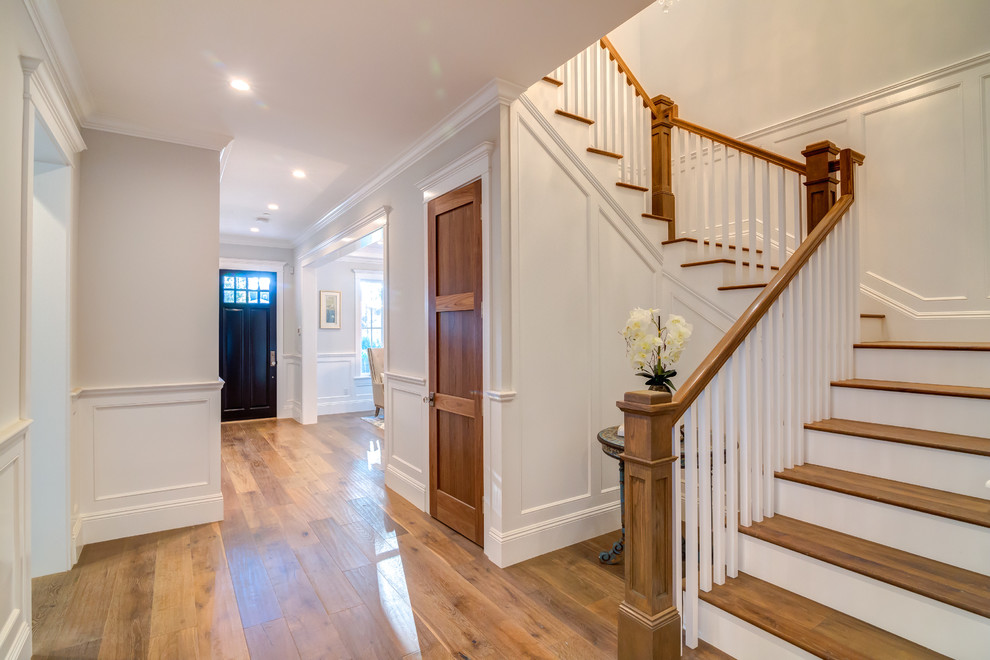 Staircase - mid-sized traditional wooden u-shaped staircase idea in Los Angeles with painted risers