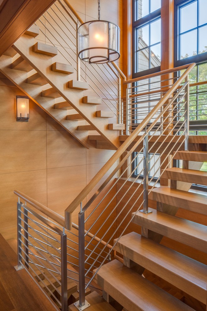 Inspiration for a contemporary wood u-shaped staircase in Boston with open risers.