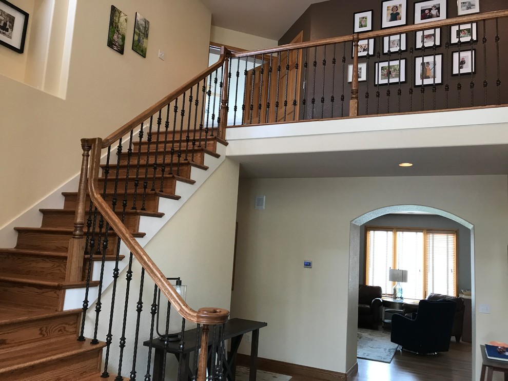 Inspiration for a medium sized traditional wood l-shaped metal railing staircase in Denver with wood risers and feature lighting.
