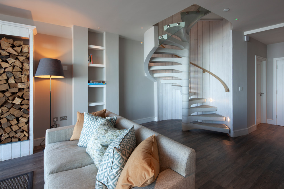 Medium sized nautical concrete spiral mixed railing staircase in Cornwall with open risers and feature lighting.