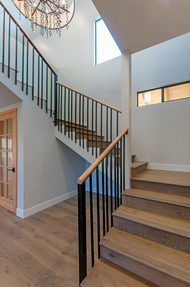 Example of a mid-sized country wooden u-shaped metal railing staircase design in San Diego with wooden risers